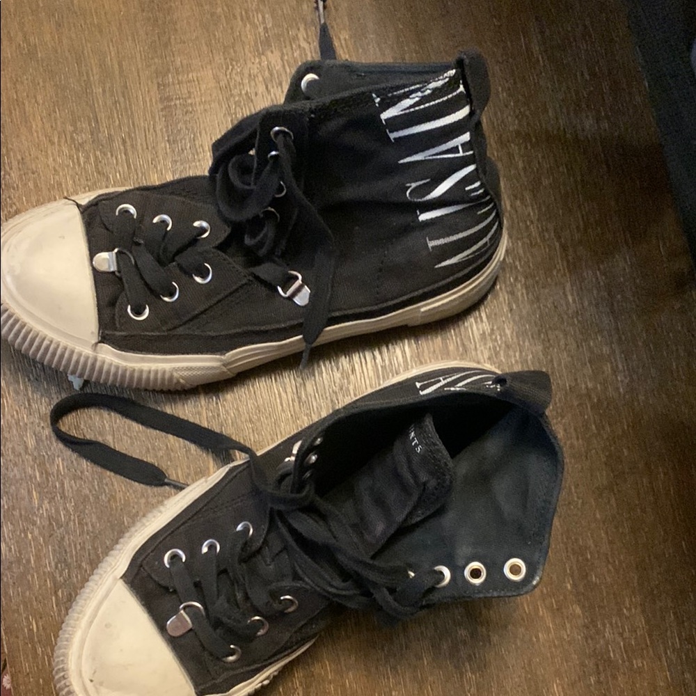 Black high-top sneakers with ribbed design and thick rubber sole